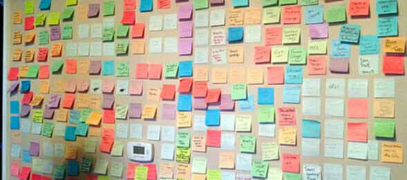 Colored post-it notes stuck on a wall during a brainstorm session