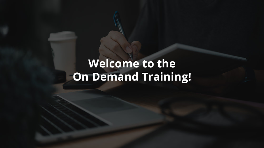 Welcome to the on demand training image with person taking notes while using laptop.